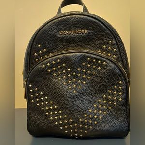 Michael Kors black leather backpack never used with gold studs. Pristine conditi